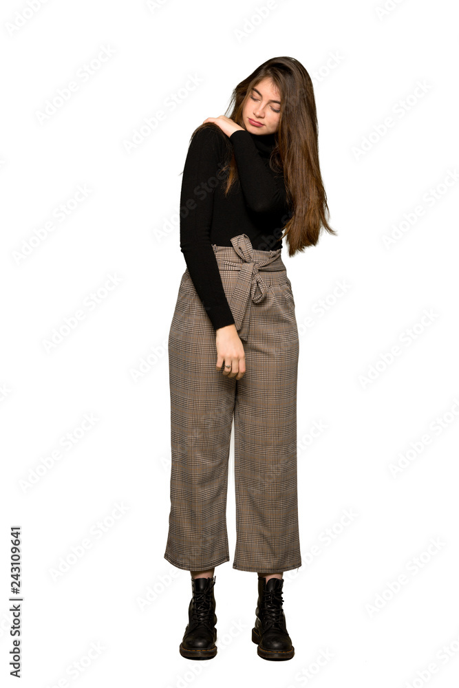 Full-length shot of Pretty girl suffering from pain in shoulder for having made an effort on isolated white background Full-length shot of Pretty girl suffering from pain in shoulder for having made an effort on isolated white background