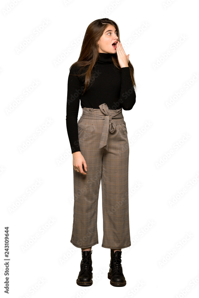 Full-length shot of Pretty girl yawning and covering wide open mouth with hand on isolated white background Full-length shot of Pretty girl yawning and covering wide open mouth with hand on isolated white background