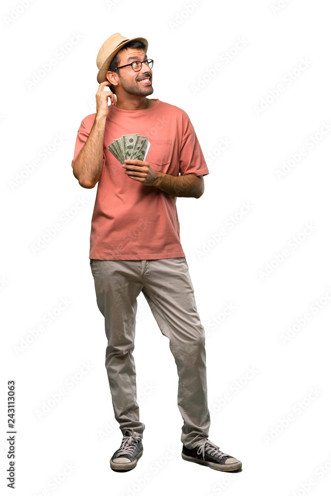 Man holding many bills standing and thinking an idea while scratching head on isolated white background Man holding many bills standing and thinking an idea while scratching head on isolated white background