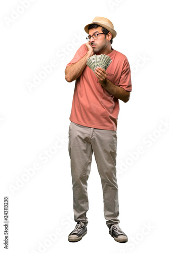 Man holding many bills covering ears with hands. Frustrated expression on isolated white background © luismolinero