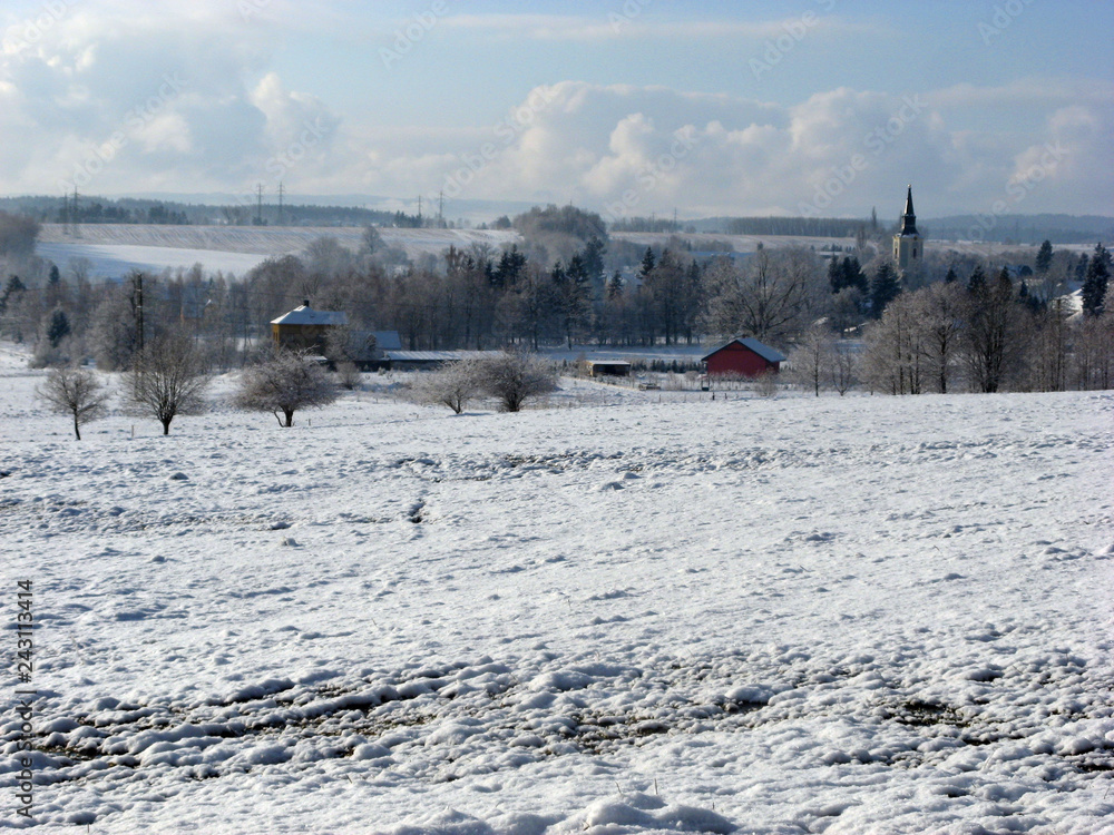 Fototapeta premium Aerial view of small village covered with fresh snow, winter time, sunny day