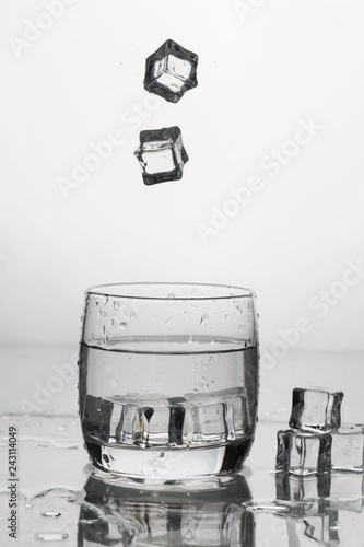water with ice in a glass with splashes