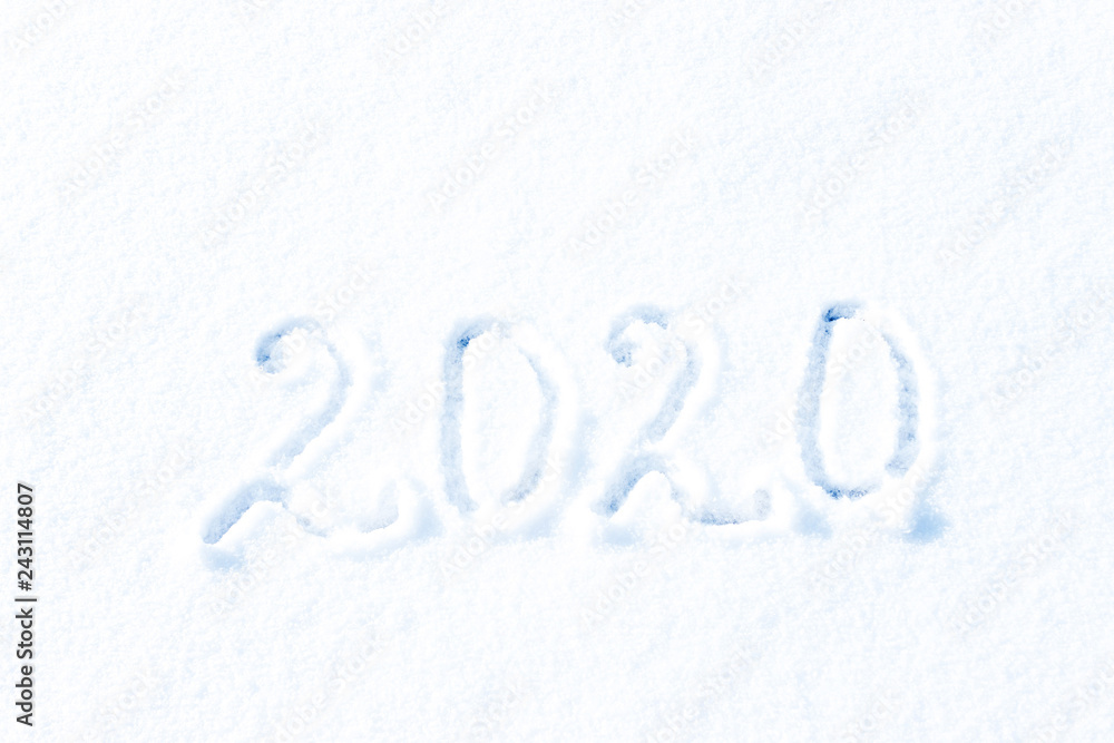 2020 New year. 2020 year painted on a snowy background. Figures two thousand and twenty of snow. 2020 New year. 2020 year painted on a snowy background. Figures two thousand and twenty of snow.