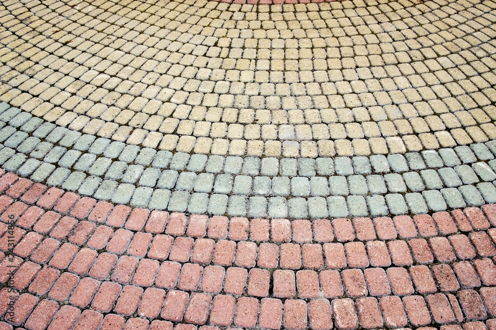 multi-colored pavement of different bricks, leaving a semicircular pavement
