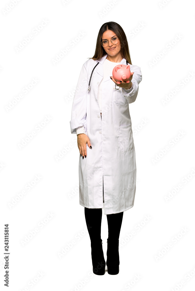 Full body of Young doctor woman holding a big piggybank Full body of Young doctor woman holding a big piggybank