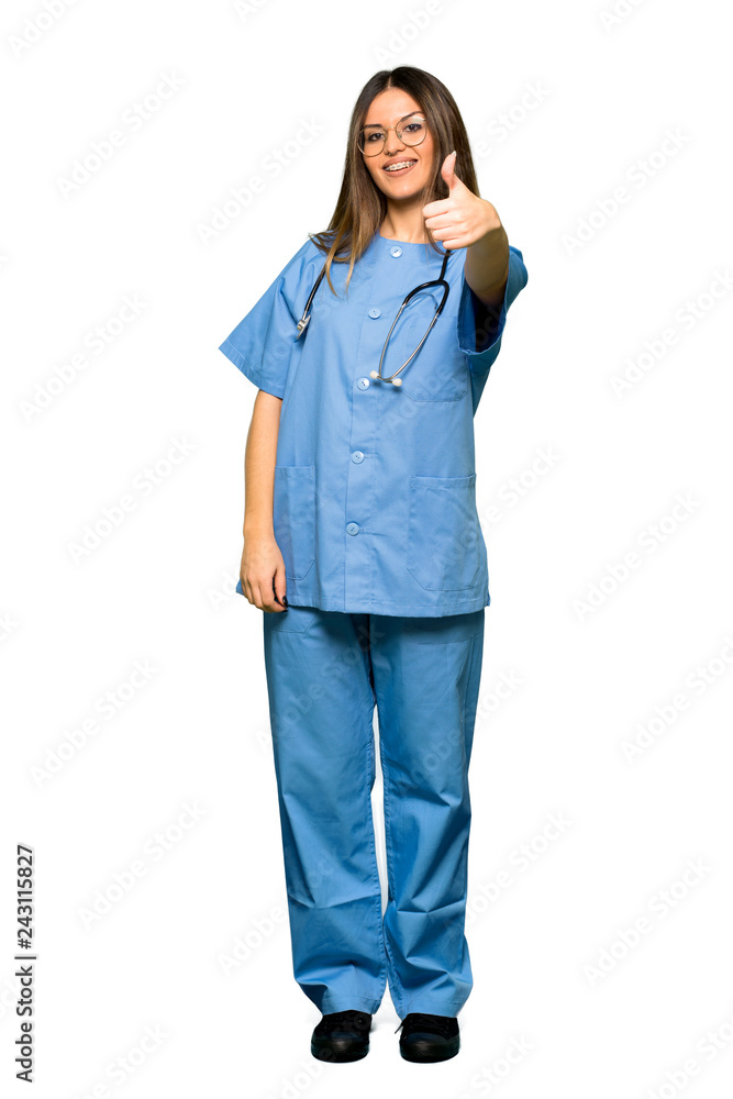 Full body of Young nurse giving a thumbs up gesture because something good has happened Full body of Young nurse giving a thumbs up gesture because something good has happened