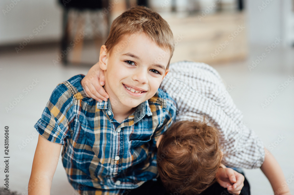 Two funny boys play together. Cute happy brothers smiling and having fun Two funny boys play together. Cute happy brothers smiling and having fun