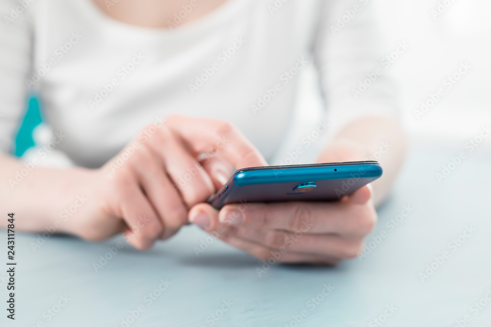 Using a smartphone close-up in the hands of a woman. Using a smartphone close-up in the hands of a woman.