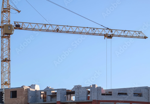 Cranes,construction crane equipment over building construction site on blue sky background on day,technology transportation material to high site.