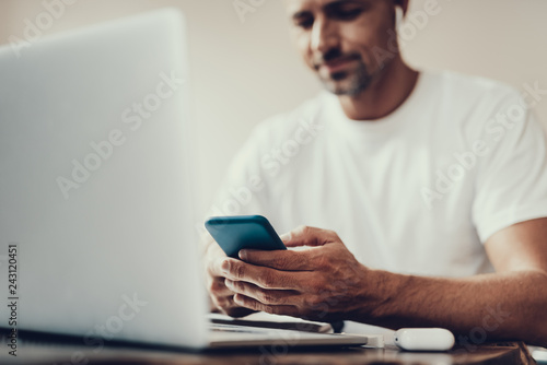 Man using new telephone while sitting in cafe