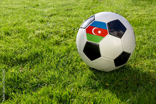 Football on a grass pitch with Azerbaijan Flag.