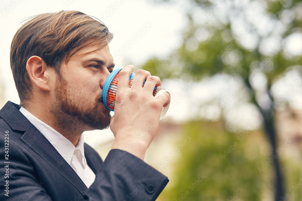 young businessman drinks coffee while he goes to work young businessman drinks coffee while he goes to work
