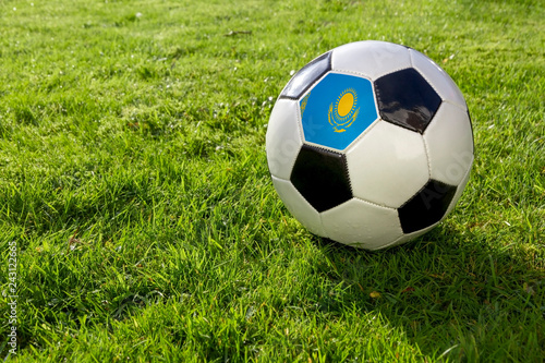Football on a grass pitch with Kazakhstan Flag