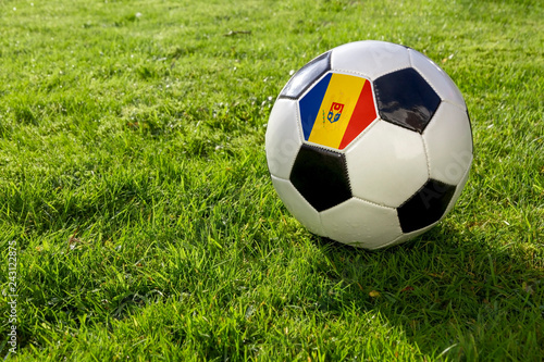 Football on a grass pitch with Moldova Flag