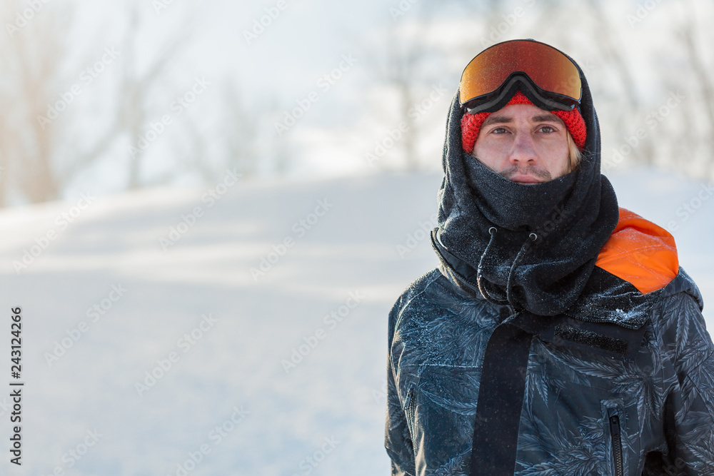 Young handsome man wearing ski mask and sport jacket loking at the camera. close up portrait. copy space. lifestyle, hobby