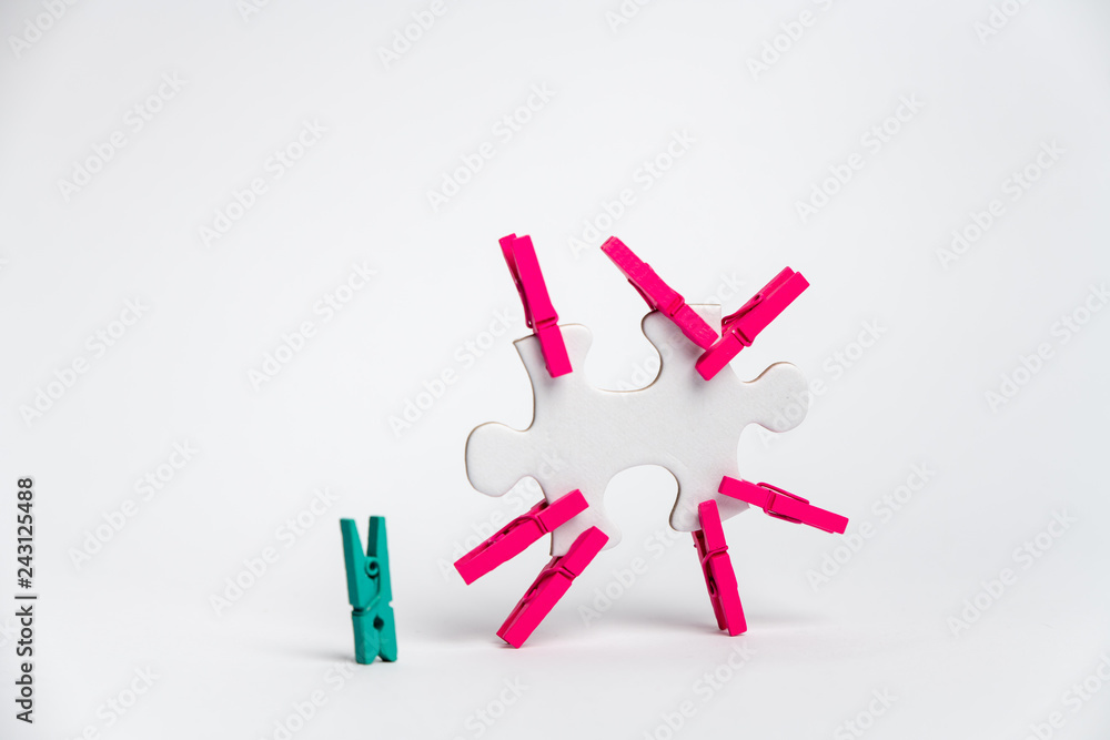 element of a clean puzzle with attached paper clips in the same color and one in a different color element of a clean puzzle with attached paper clips in the same color and one in a different color