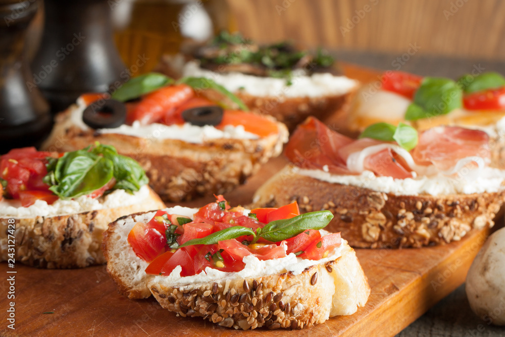 Italian tomato and cheese bruschetta. Tapas, antipasti with chopped vegetables, herbs and oil on grilled ciabatta and baguette bread. Italian tomato and cheese bruschetta. Tapas, antipasti with chopped vegetables, herbs and oil on grilled ciabatta and baguette bread.