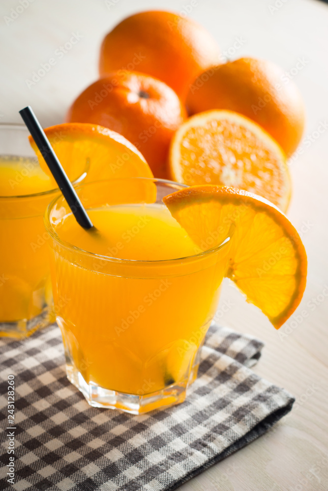 Photo of fresh orange juice in the glass jar. Summer healthy organic drink concept. Cold beverages with ice and orange fruits. Photo of fresh orange juice in the glass jar. Summer healthy organic drink concept. Cold beverages with ice and orange fruits.