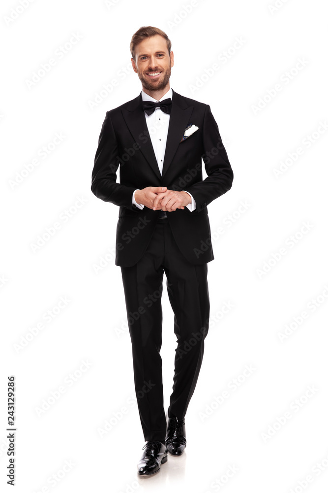 attractive businessman holds palms together and steps forward attractive businessman holds palms together and steps forward