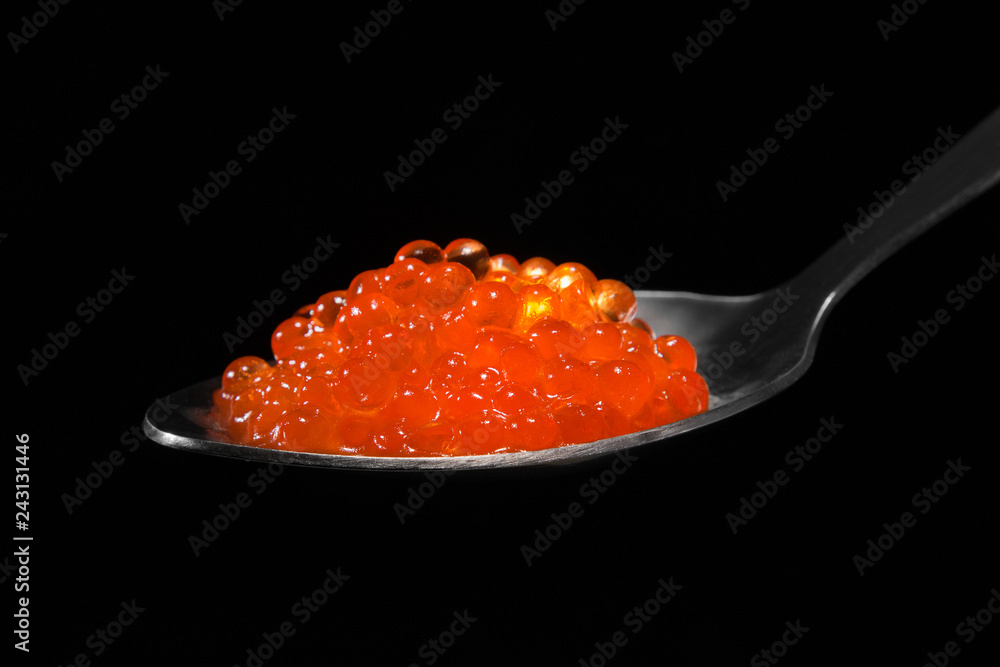 Red caviar in a spoon close-up. Red caviar in a spoon close-up.