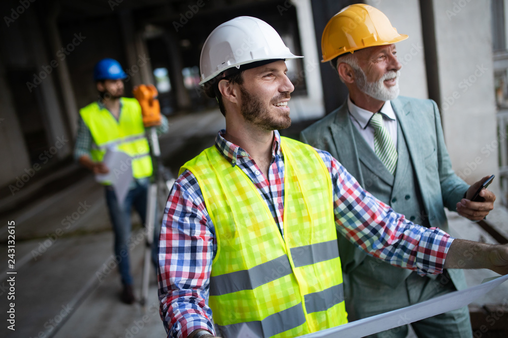 Engineer, foreman and worker discussing in building construction site Engineer, foreman and worker discussing in building construction site