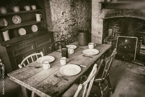 Принти на полотні Poor peasants interior from 19th century, dining room with set wooden table and