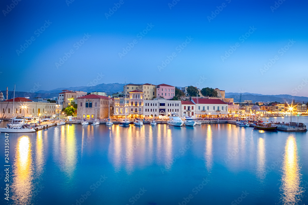 Travel Concepts. Picturesque Image of Old Venetian Harbour of Chania with Fisihing Boats and Yachts on the Foregound Taken At Blue Hour in Crete, Greece