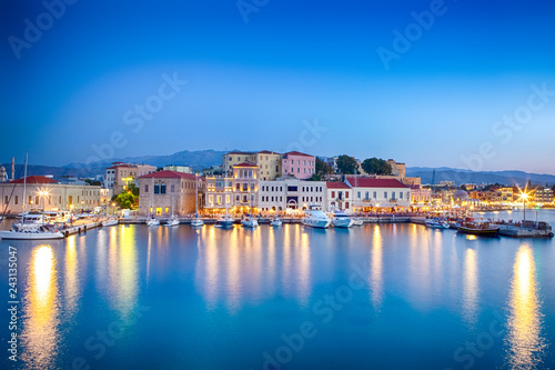 Travel Concepts. Picturesque Image of Old Venetian Harbour of Chania with Fisihing Boats and Yachts on the Foregound Taken At Blue Hour in Crete, Greece © danmorgan12