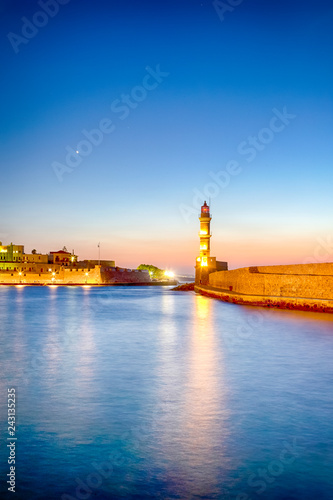 Old Venetian Port in Chania and Ancient Lighthouse on Pier. © danmorgan12