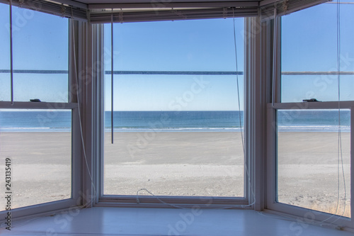box bay window overlooking beautiful beach with no one on it © Lauren