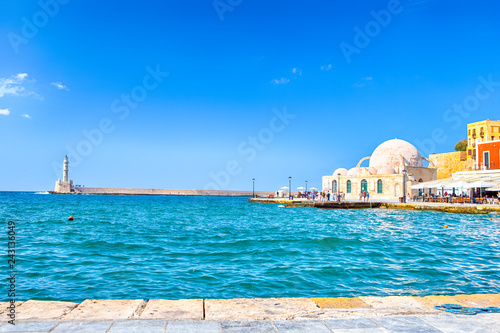 Travel ideas. Chania Old Port and Venetian Harbor With Ancient Lighthouse on Background.