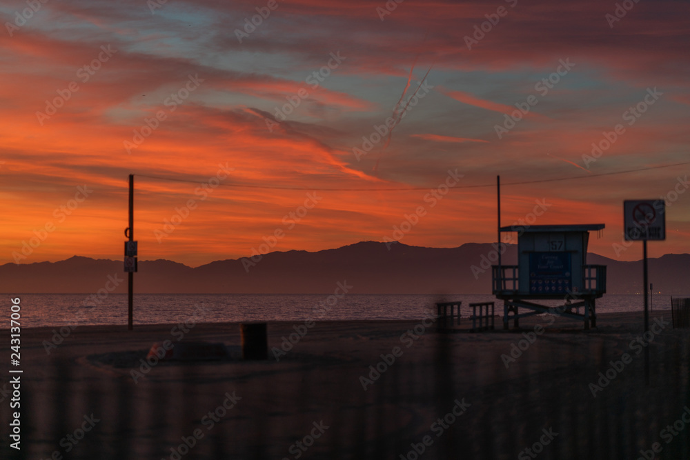 Baywatch station on beach at sunset