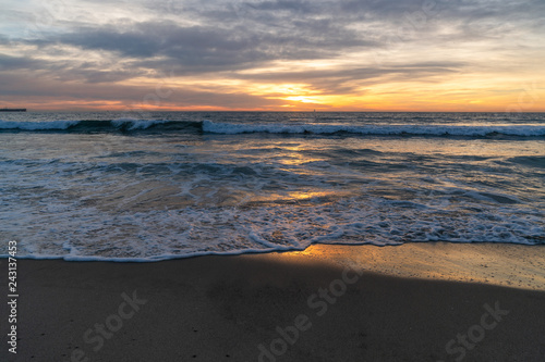 View of sea and waves at sunset