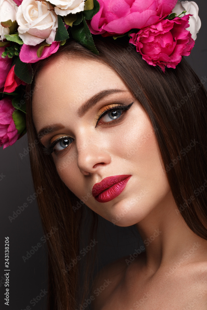 Beautiful girl with bright make-up and flowers on her head. Beauty face.