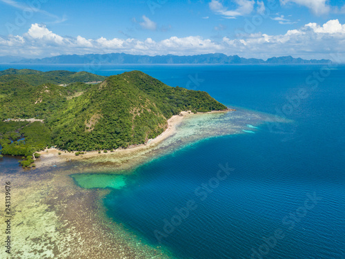 Aerial view of tropical island Tampel. Beautiful tropical island with sand beach, palm trees. Travel tropical concept. Palawan, Philippines