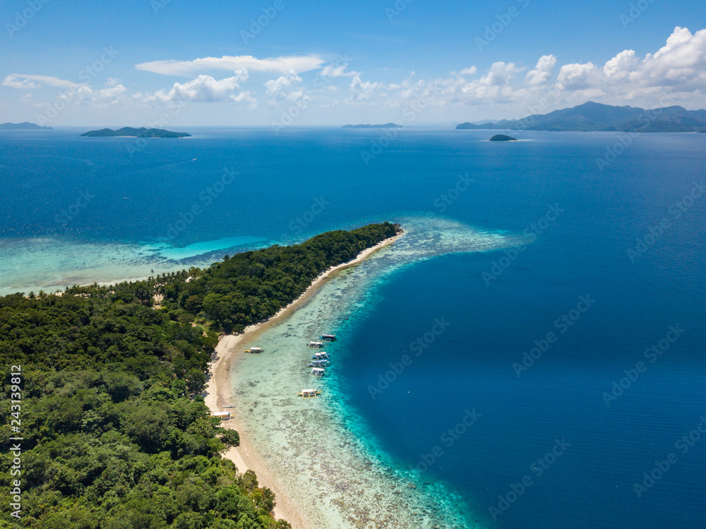 Aerial view of tropical beach on the island Malcapuya. Beautiful tropical island with sand beach, palm trees. Travel tropical concept. Palawan, Philippines