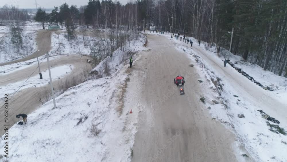 Russia, Championship on snowmobiles January 27, 2018: Winter racing on snowmobiles. Aerial view: Snowmobile on the route in a jump. Action from snowmobile races. Russia, Championship on snowmobiles January 27, 2018: Winter racing on snowmobiles. Aerial view: Snowmobile on the route in a jump. Action from snowmobile races.