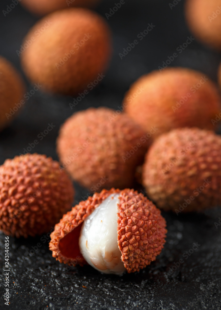 Tropical Lychee fruits, soapberry on rustic black table, background Tropical Lychee fruits, soapberry on rustic black table, background