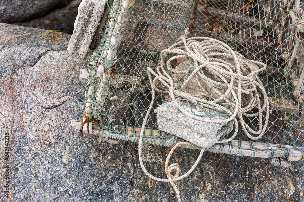 Gray sea ropes lie in a heap in fishing port.Thailand.