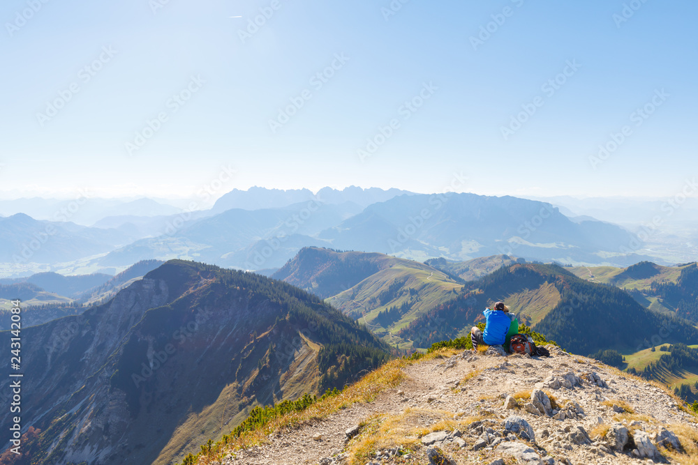 HIkers enjoy view on mountain peak at Mountain Geigelstein, Schleching, Bavaria