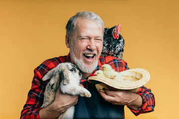 positive kind man embracing animals on the farm. close up photo.pleasure.friendship