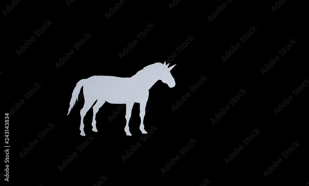 Fototapeta premium White unicorn with paper on a black background