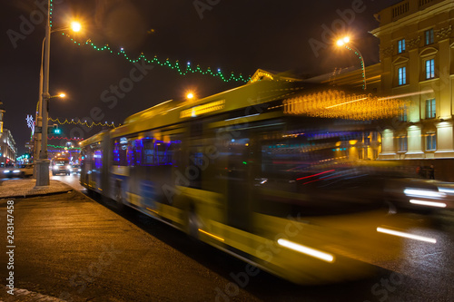 Motion blurred bus on the avenue in the evening in winter.