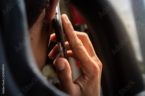 Back view of a man making a call in the public transportation/ close up of a man making a call to his friend