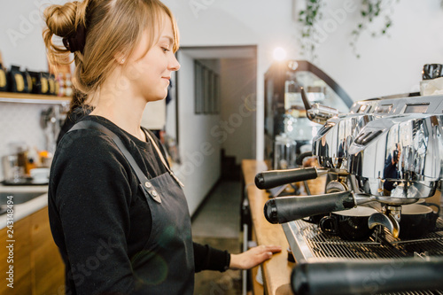 Caucasian female baristas preparing coffee at coffee-shop. Team work and coworkers concept.