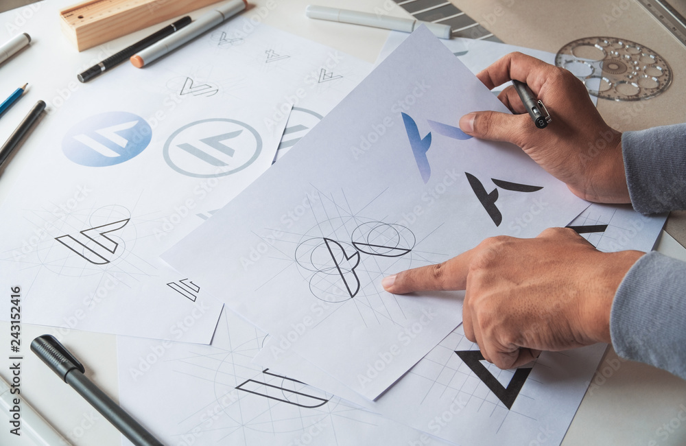Graphic designer drawing sketch design creative Ideas draft Logo product trademark label brand artwork. Graphic designer studio Concept. Graphic designer drawing sketch design creative Ideas draft Logo product trademark label brand artwork. Graphic designer studio Concept.