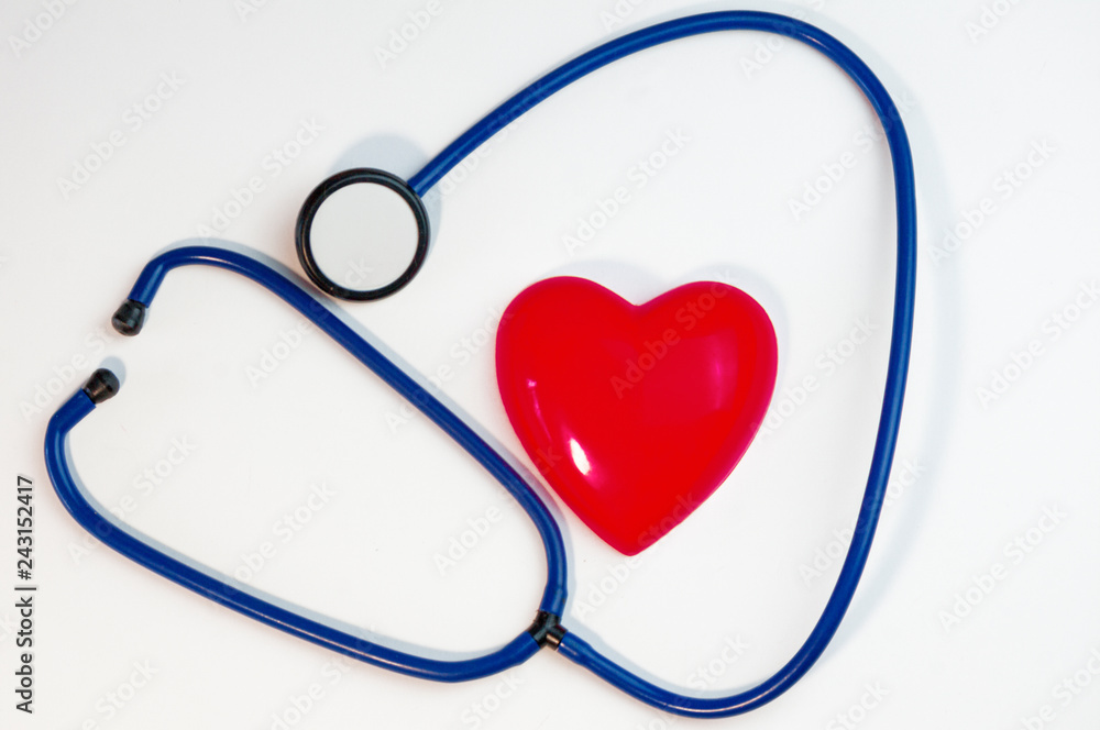 red heart and a stethoscope lying on a white background red heart and a stethoscope lying on a white background