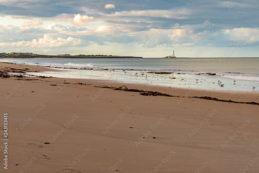 The Whitley Sands beach in Whitley Bay, Tyne And Wear, England, UK - looking north towards St. Mary's Lighthouse