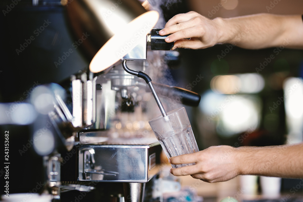 A modern expensive coffee machine is shown in work in  modern cozy coffee shop.