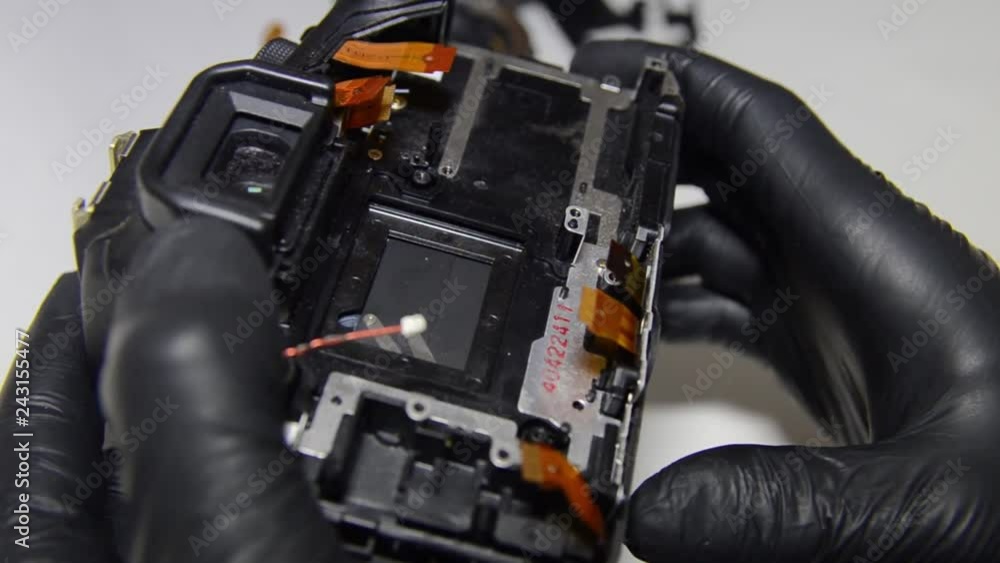 camera repair, cleaning the disassembled camera from the dust matrix. camera repair, cleaning the disassembled camera from the dust matrix.